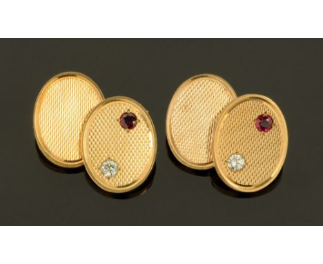 A pair of 9 ct gold cufflinks with chain connections, four engine turned oval plates, one plate of each half link set with a 
