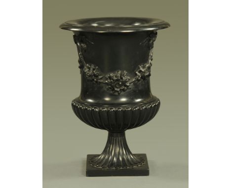 A composition garden urn, campana shaped with moulded ribbon and swags.  Height 56 cm, diameter 40 cm.