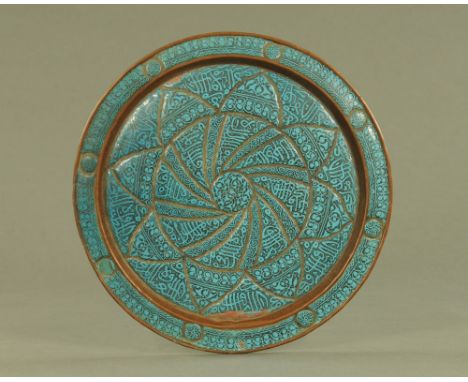 An 18th/19th century Persian Islamic enamelled copper charger.  diameter 38 cm. CONDITION REPORT: The plaque has some damage.