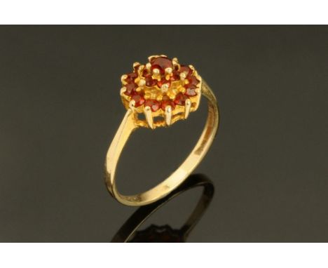 A 9 ct gold garnet set cluster ring, Size K.