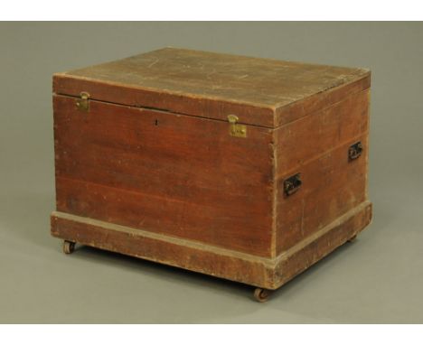 A large 19th century camphorwood rectangular trunk, of plain design, two pairs of wrought iron handles to the sides on moulde