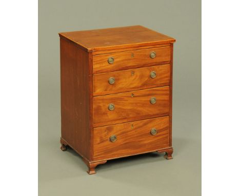 A mahogany chest of drawers, of small proportions, four long drawers with brass drop handles and all raised on ogee moulded b