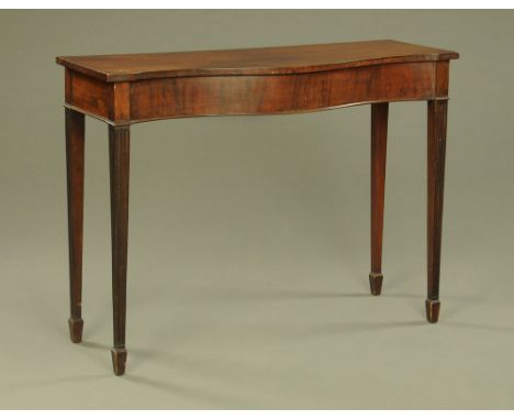 A 19th century mahogany serpentine fronted console table, raised on tapered fluted legs terminating in spade feet.  Height 88