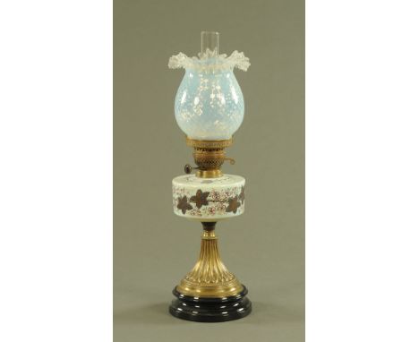 A Victorian oil lamp, with Vaseline glass shade painted reservoir brass and glass base beneath.  Height including chimney 62 