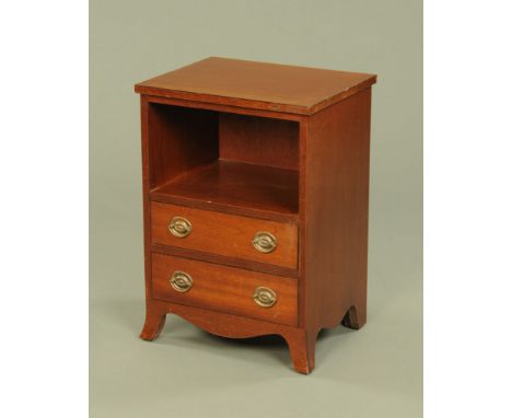 A mahogany bedside cabinet, with open aperture above two drawers with brass drop handles with shaped apron below and splayed 