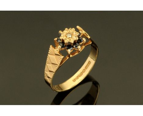 A 9 ct gold diamond and sapphire cluster ring, Size K.