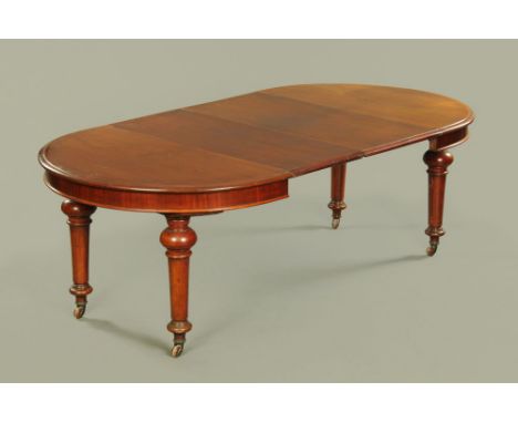 A Victorian mahogany extending dining table of moulded circular form, with 2 additional leaves raised on turned tapering legs