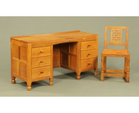 A Mouseman Thompson of Kilburn oak kneehole desk, with shallow rear upstand and fitted with three drawers to each pedestal wi