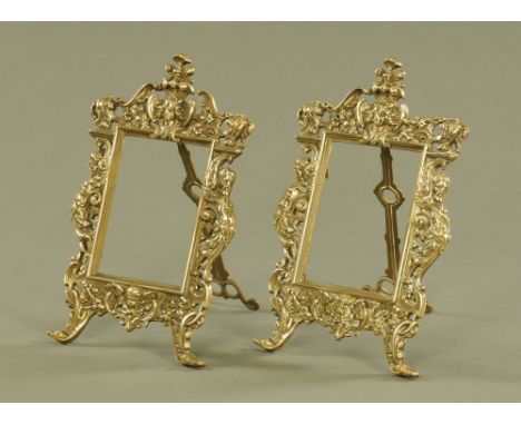 A pair of moulded brass easel back photograph frames.  Height 28 cm, width 18 cm.