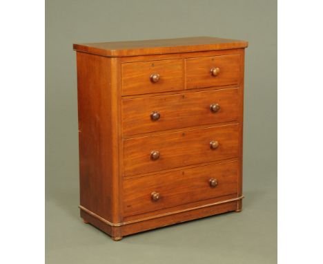 A Victorian mahogany chest of drawers, with rounded corners above two short and three long graduated drawers with wooden knob