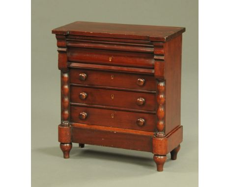 A Victorian mahogany miniature Scotch chest of drawers, with inverted breakfront, four drawers and raised on short turned fee