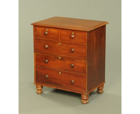 A 19th century mahogany commode chest, modelled as two short and three long drawers with wooden knob handles and raised on tu