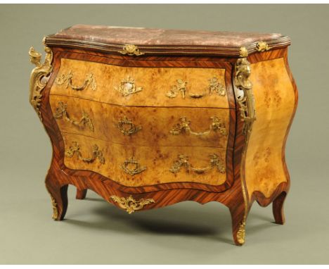 A Louis XV style walnut and Kingwood veneered commode chest of drawers, with red marble top and brass mounts, fitted with thr