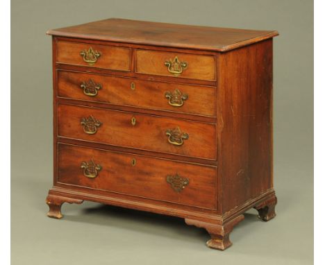 A George III mahogany chest of drawers, with moulded edge above two short and three long drawers with brass drop handles and 