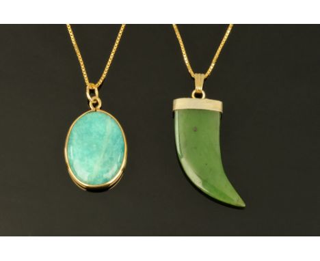 Two 9 ct gold pendants, one in the form of a green jade "claw" and another oval.