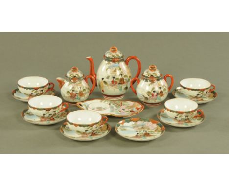 A Japanese Satsuma part tea service, six saucers, five cups, sugar basin, cream jug and teapot and another saucer.
