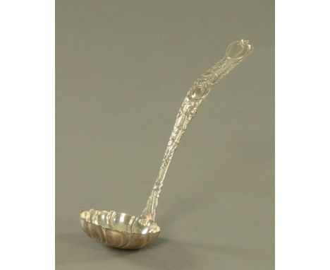 An early 20th century American cast silver punch ladle by Tiffany & Co, of Art Nouveau design, cast with fruiting vines and w