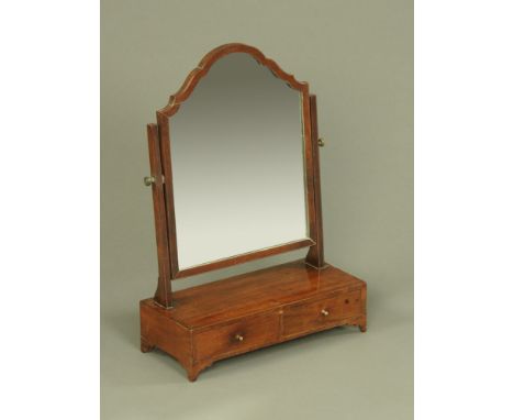 A George III mahogany toilet mirror, with arched pediment and angled supports and fitted with two drawers to the base.  Width