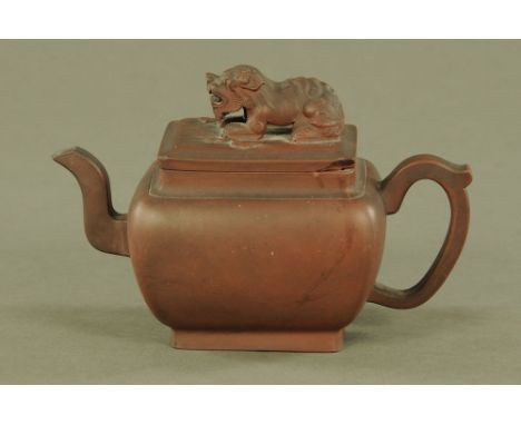 A Chinese Yixing teapot, with dog terminal.  Height 14 cm, length 22 cm. CONDITION REPORT: The lid has a break and loss to on