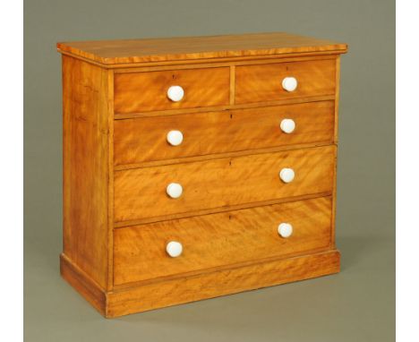 A Victorian satin walnut chest of drawers, two short and three long with ceramic knob handles and with plinth base.  Height 1