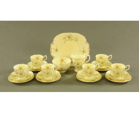 A Crown Staffordshire daffodil patterned half tea set, comprising six cups, six saucers, six plates, sugar basin, milk jug, s