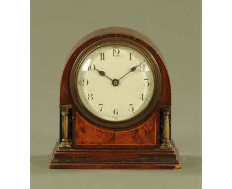 An Edwardian inlaid mahogany mantle clock, with single train movement with brass pillars to either side.  Height 15 cm.