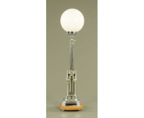 An Art Deco Gothic style chrome plated table lamp, with milk glass shade.  Overall height 86 cm. CONDITION REPORT: The lamp i
