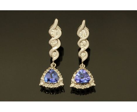 A pair of 18 ct white gold earrings, each set with a trilliant cut tanzanite to diamond drop and halo, total weight +/- 1.75 