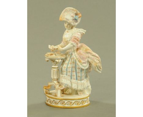 A Meissen figure of a female card player, 19th century after the model by Michel Victor Acacier, with blue crossed swords mar