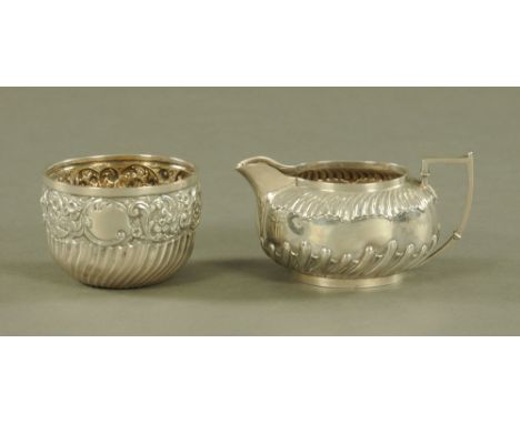 A silver cream jug, Sheffield 1892, together with a sugar basin, London 1897, combined weight 205 grams.