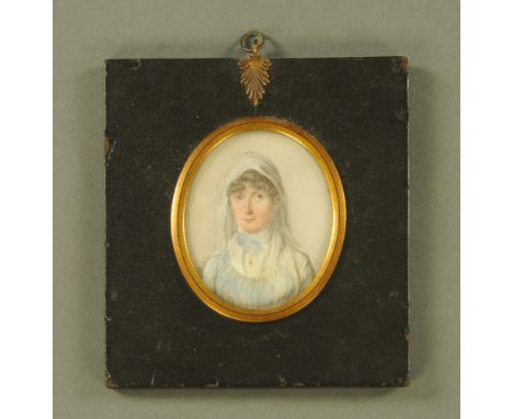 A 19th century portrait miniature, an elderly lady wearing a white and blue smock. 7 cm x 6 cm, framed.
