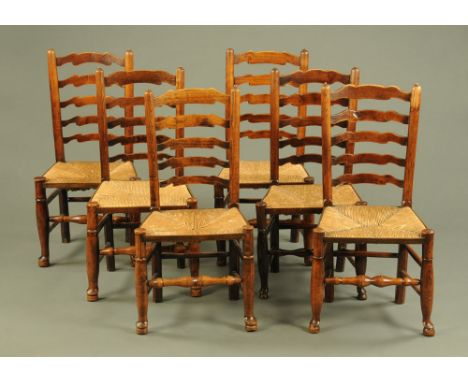 A matched set of six 19th century rush seat ladder backed dining chairs, each raised on turned legs with stretchers and termi