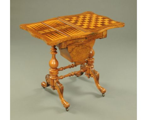 A Victorian walnut combined games and worktable, cribbage, backgammon and chess, with sliding bag, turned supports and cabrio