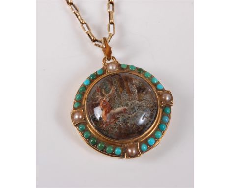 A reverse painted intaglio pendant and chain, the round domed reverse painted intaglio of a stag in the forest, with turquois
