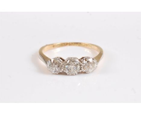 An 18ct and platinum three stone diamond ring, the three round brilliant cut diamonds, total estimated approx. 0.80cts, all c