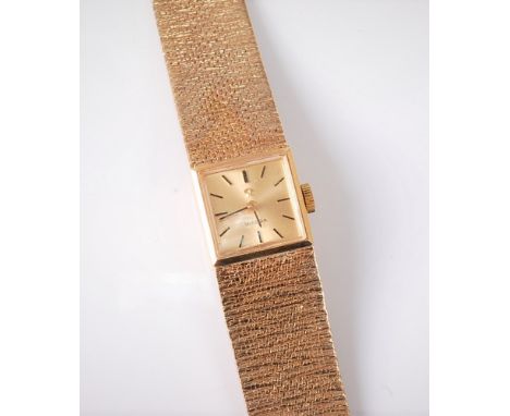 A lady's 9ct Omega manual wristwatch, the square dial with baton numerals, 14mm wide, with tapering textured bracelet strap a