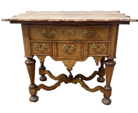 A Queen Anne style walnut veneered ‘Dutch Baroque’ side table, with a wide shaped and quarter veneered and feather banded top