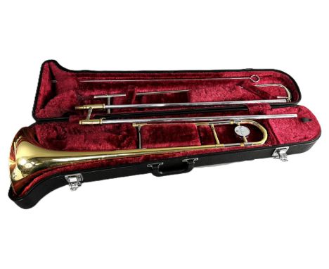 A Yamaha trombone with traveling case.