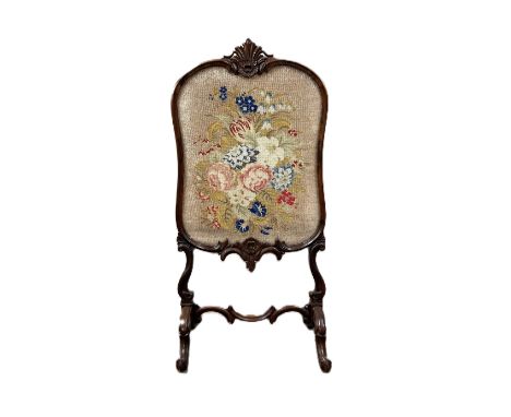 A rococo style rosewood fire screen with gros point and bead work panel, 106 x 53 cm.  The Alastair & Sheila Brooks Collectio