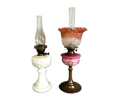 A oil lamp with pink glass reservoir on copper base, 67 cm to top of shade, and another milk glass lamp, (2).   The Alastair 