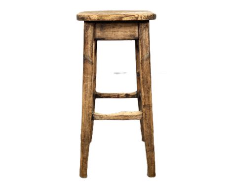 A pine high stool with pierced handle to seat on supports united by stretchers, 77 x 34 x 34 cm.  The Alastair & Sheila Brook