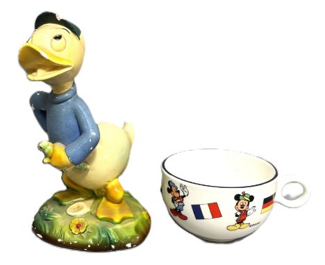 A 1930/40s Walt Disney figure of a young duck in blue, later identified as Dewey duck, incised W/36, 18 cm, and a Disneyland 