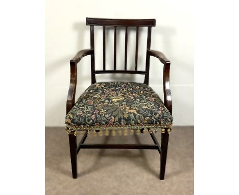 A mahogany open arm chair with with tapestry style seat upholstery and tassels, 88 x 56 x 52 cm.  The Alastair & Sheila Brook