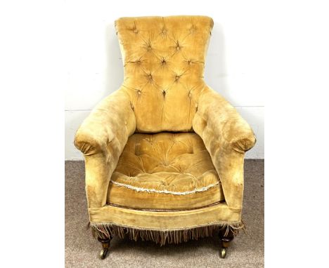 A Victorian arm chair with button back and arms, on front turned supports, rear castors marked Cope's, 93 x 75 x 95 cm.   The