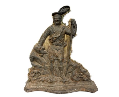 A cast iron flatback figure of a Scotsman, possibly holding a bow and with feathers in hat, 35 cm.   The Alastair & Sheila Br