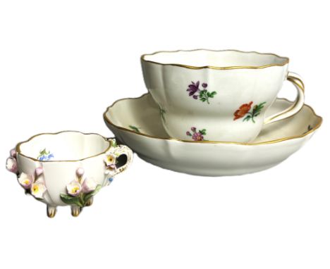 A Meissen breakfast cup and saucer with floral and gilt decoration, 8 x 11.5 cm, and a small Meissen footed cup with floral a