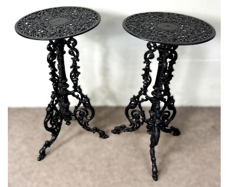 A pair of cast iron garden plant stands / occasional tables, of pierced scrolling design on tripod base, 76 cm.