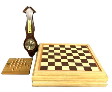 A modern board and card game compendium, 7 x 36 x 36 cm, a solitaire game and a wall barometer, (3).  The Alastair & Sheila B