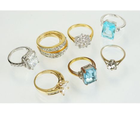 Seven stone set dress rings to include a tru gems white stone ring, cluster ring, two blue stone examples, stone ring set wit