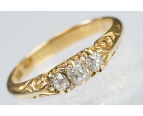 Early 20th Century 18ct gold and diamond three stone ring rectangular cut diamonds set to a scrolled mount. Marked 18ct to sh